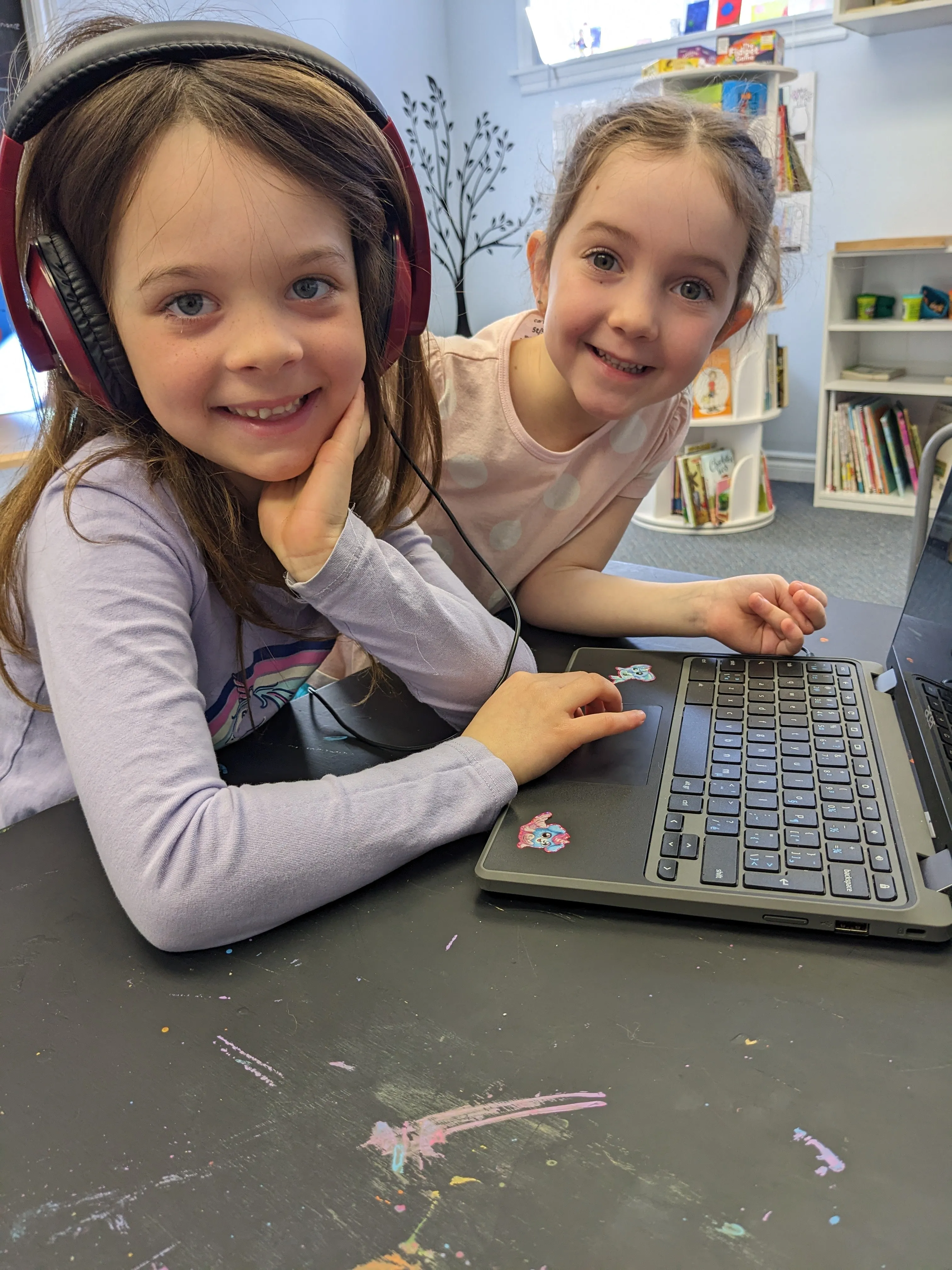 Two learners working together at a laptop in the studio